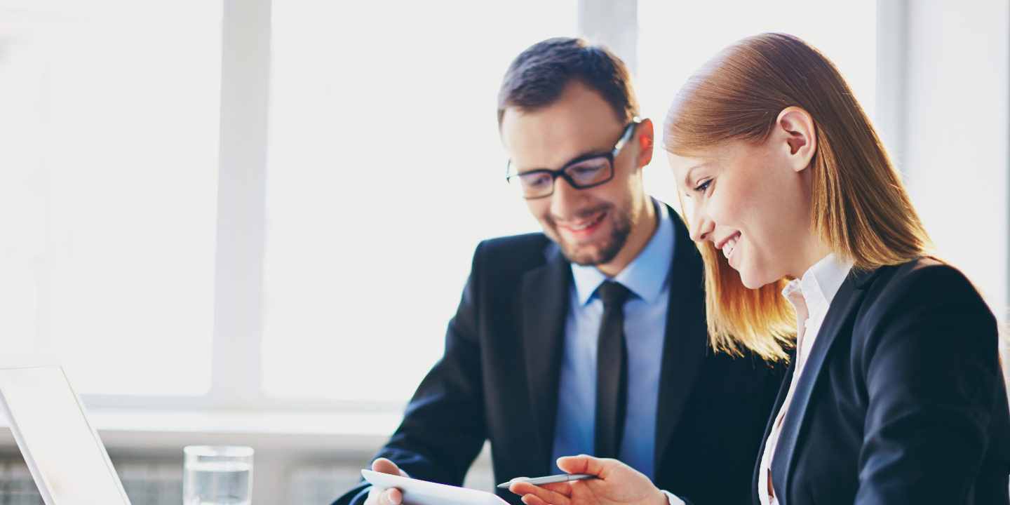 Business man and woman looking at tablet